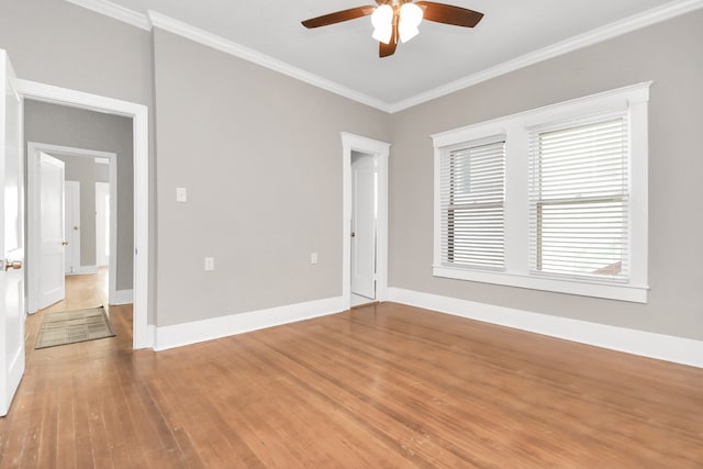 empty room featuring crown molding, ceiling fan, and wood-type flooring