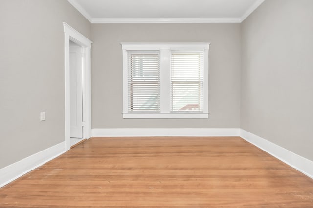 unfurnished room featuring hardwood / wood-style floors and crown molding