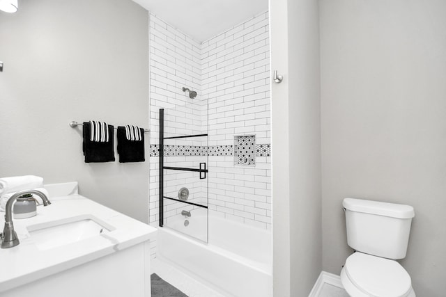 full bathroom with toilet, vanity, and tiled shower / bath