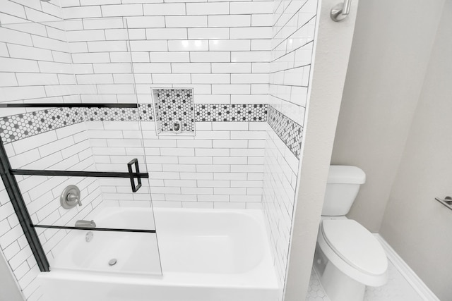 bathroom featuring tiled shower / bath combo and toilet