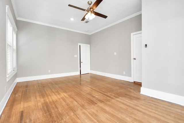 unfurnished room featuring light hardwood / wood-style flooring, a wealth of natural light, and crown molding