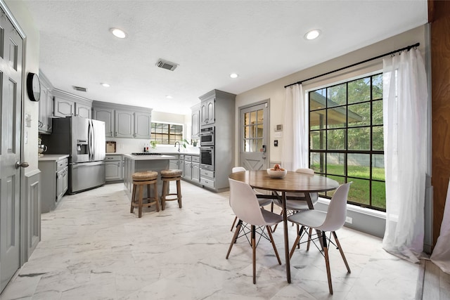 dining space with a healthy amount of sunlight and a textured ceiling