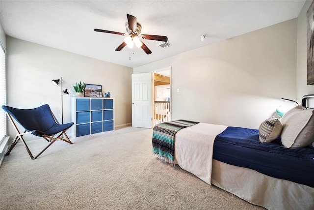 carpeted bedroom featuring multiple windows and ceiling fan