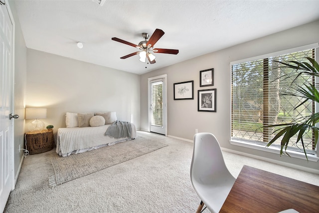 bedroom featuring carpet flooring, multiple windows, and ceiling fan