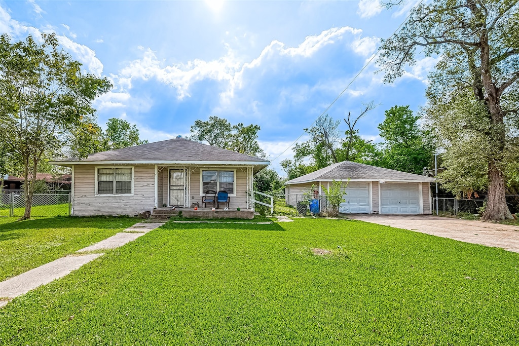 view of front of property with a garage and a front lawn