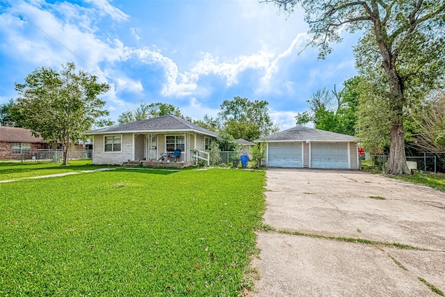 ranch-style house with an outbuilding, a porch, a front yard, and a garage