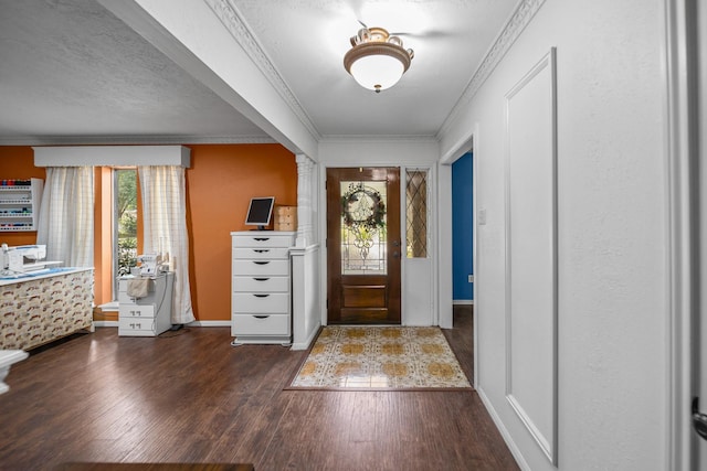 entryway featuring a textured ceiling, crown molding, and dark hardwood / wood-style floors