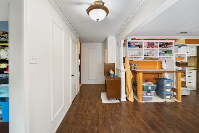 hall with a textured ceiling, crown molding, and dark hardwood / wood-style floors