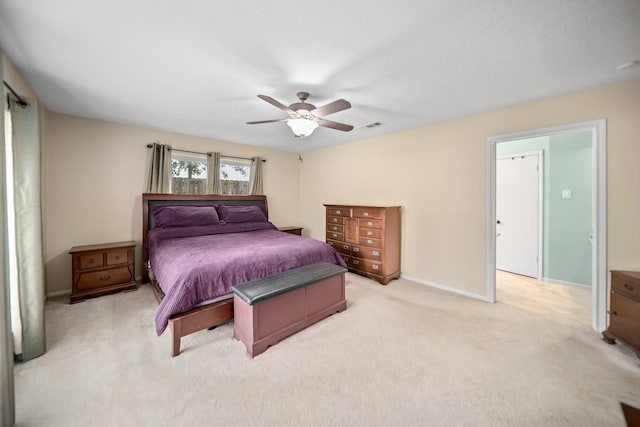 bedroom featuring ceiling fan and light carpet