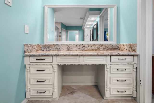 bathroom with tile patterned flooring and vanity