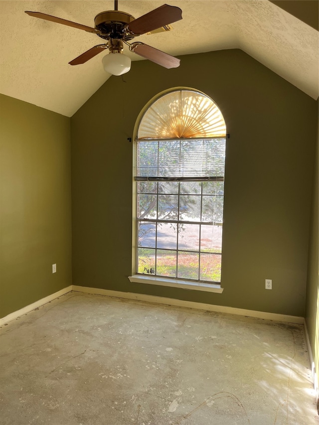 unfurnished room with a textured ceiling, ceiling fan, and vaulted ceiling