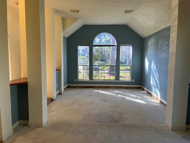 interior space featuring lofted ceiling and a textured ceiling