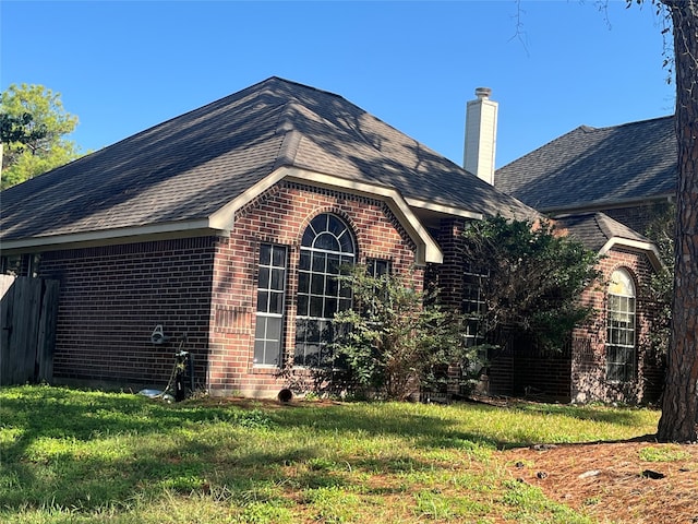 view of property exterior with a yard