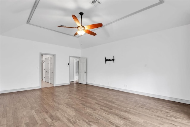 empty room featuring ceiling fan and light hardwood / wood-style flooring