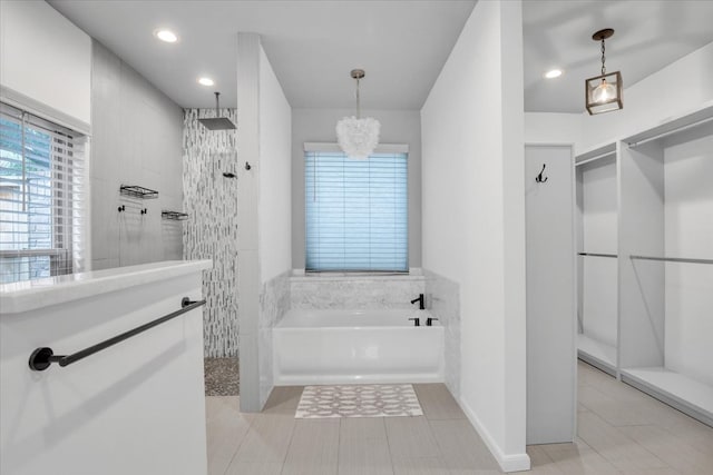 bathroom with shower with separate bathtub, tile patterned floors, and an inviting chandelier