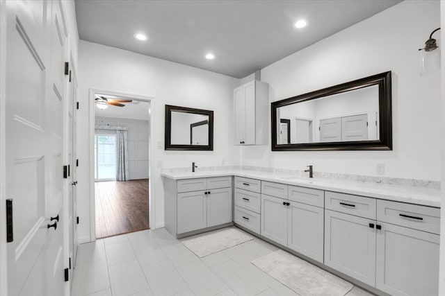 bathroom featuring hardwood / wood-style floors, vanity, and ceiling fan