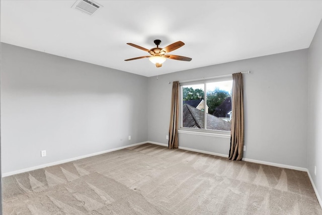 empty room with light colored carpet and ceiling fan