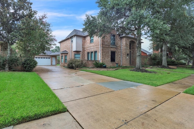 view of front of home with a front lawn and a garage