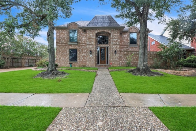 french country style house featuring a front lawn