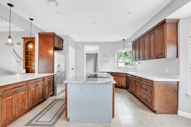 kitchen with hanging light fixtures, stainless steel appliances, light tile patterned floors, and a kitchen island