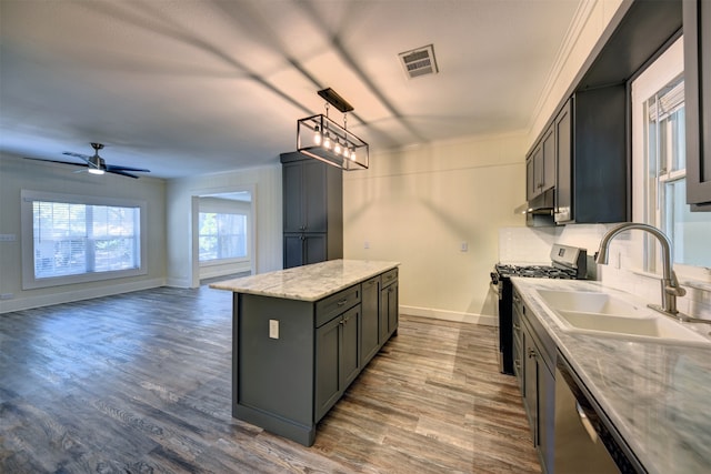 kitchen featuring a kitchen island, appliances with stainless steel finishes, dark hardwood / wood-style flooring, pendant lighting, and sink