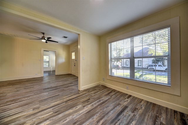 empty room featuring hardwood / wood-style flooring, ceiling fan, and crown molding