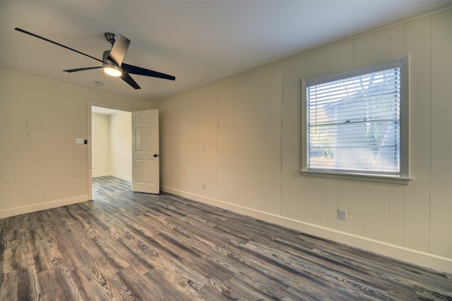 unfurnished room with dark hardwood / wood-style flooring and ceiling fan