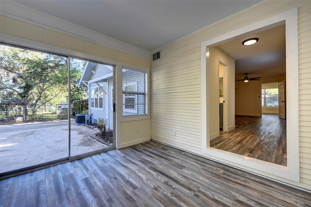 unfurnished sunroom with ceiling fan and a healthy amount of sunlight