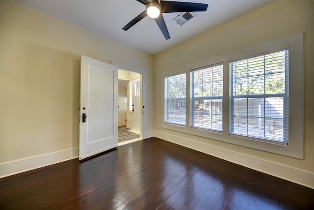 spare room featuring ceiling fan and dark hardwood / wood-style flooring