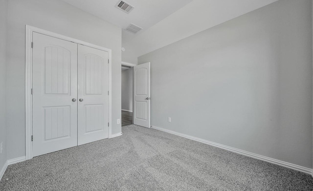 unfurnished bedroom with carpet and a closet