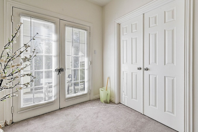 doorway with a wealth of natural light and light colored carpet