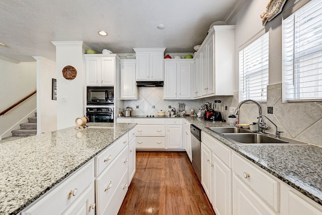 kitchen with white cabinetry, sink, black appliances, ornamental molding, and dark hardwood / wood-style flooring