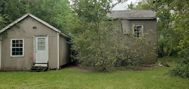 view of outbuilding with a yard