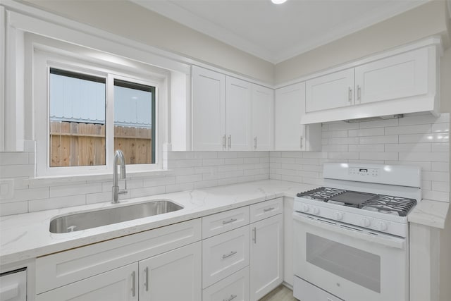 kitchen featuring light stone countertops, white gas range oven, white cabinetry, and sink