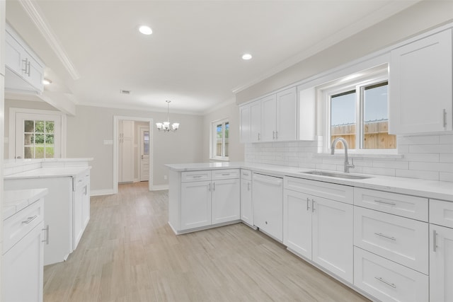 kitchen featuring white dishwasher and white cabinetry