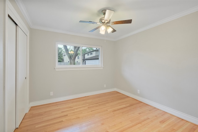 unfurnished bedroom with ceiling fan, a closet, ornamental molding, and light hardwood / wood-style flooring