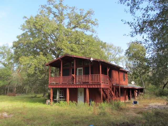 back of house with a deck