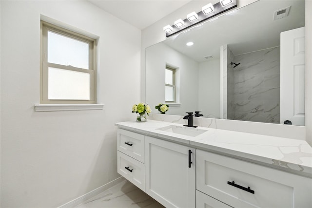 bathroom featuring vanity and a tile shower