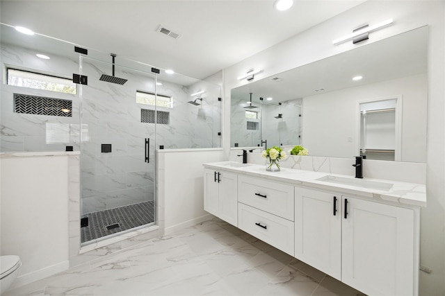 bathroom featuring toilet, vanity, and walk in shower