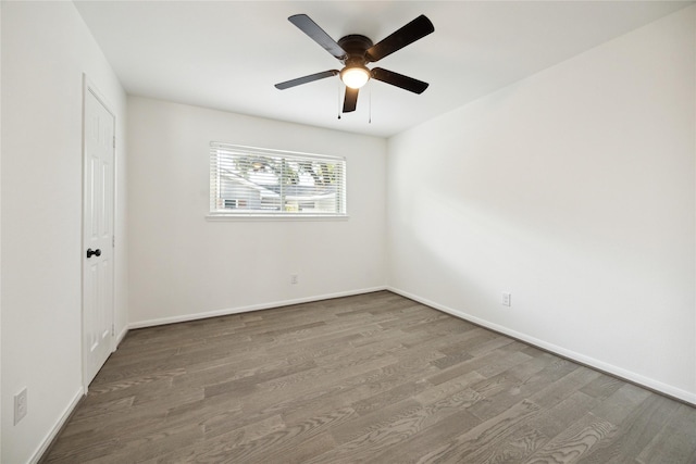 spare room with ceiling fan and wood-type flooring