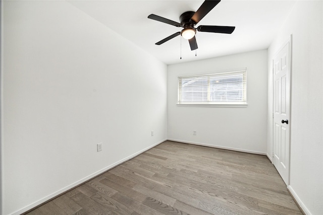 spare room with ceiling fan and light wood-type flooring