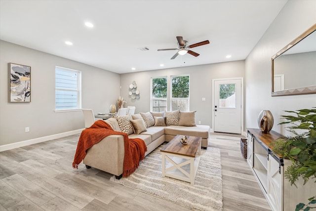 living room with ceiling fan and light wood-type flooring