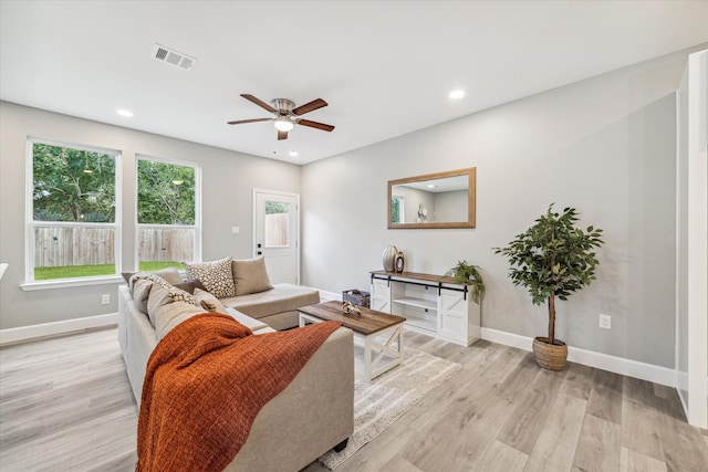 living room with light hardwood / wood-style flooring and ceiling fan