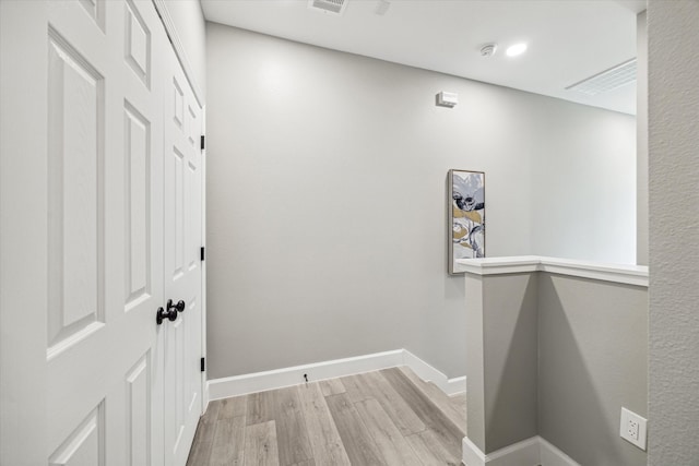 corridor with light hardwood / wood-style flooring