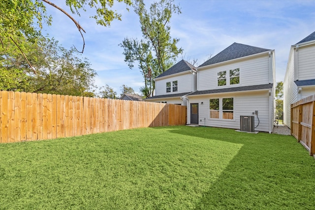 rear view of house featuring a lawn