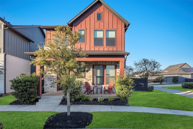 view of front of home with a patio area and a front yard