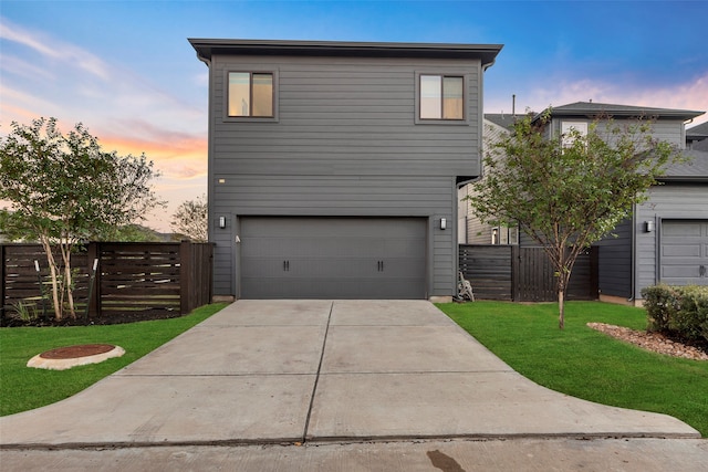 view of front facade with a garage and a yard