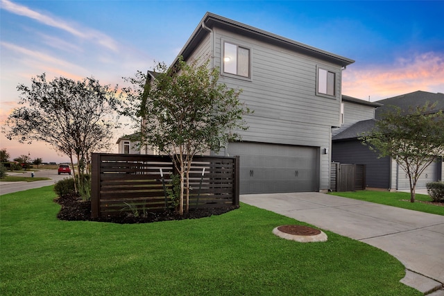 view of front facade with a yard and a garage