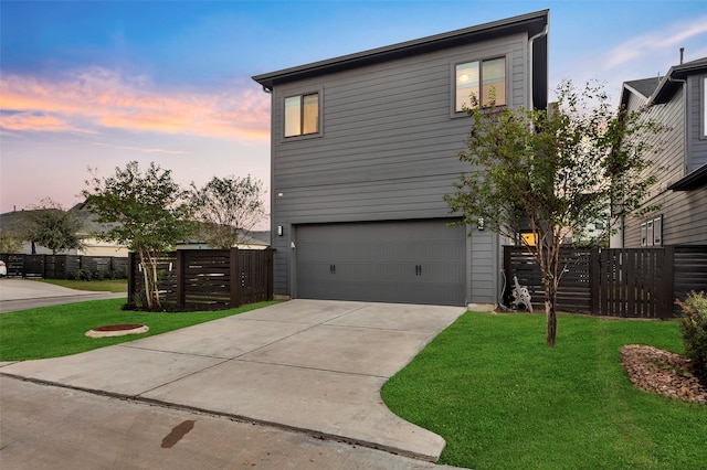 property exterior at dusk featuring a yard and a garage