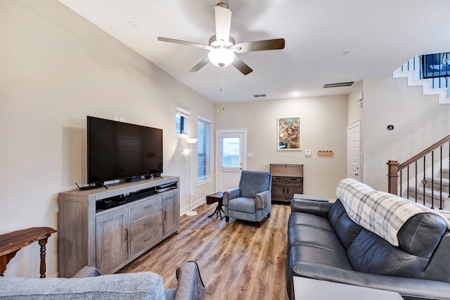 living room with ceiling fan and light wood-type flooring